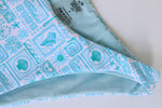 Patterned fabric with blue and white design on a white background